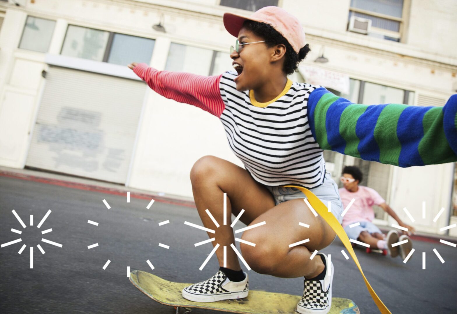 A women smiling and skate boarding